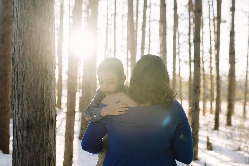twin cities mom embraces son in winter