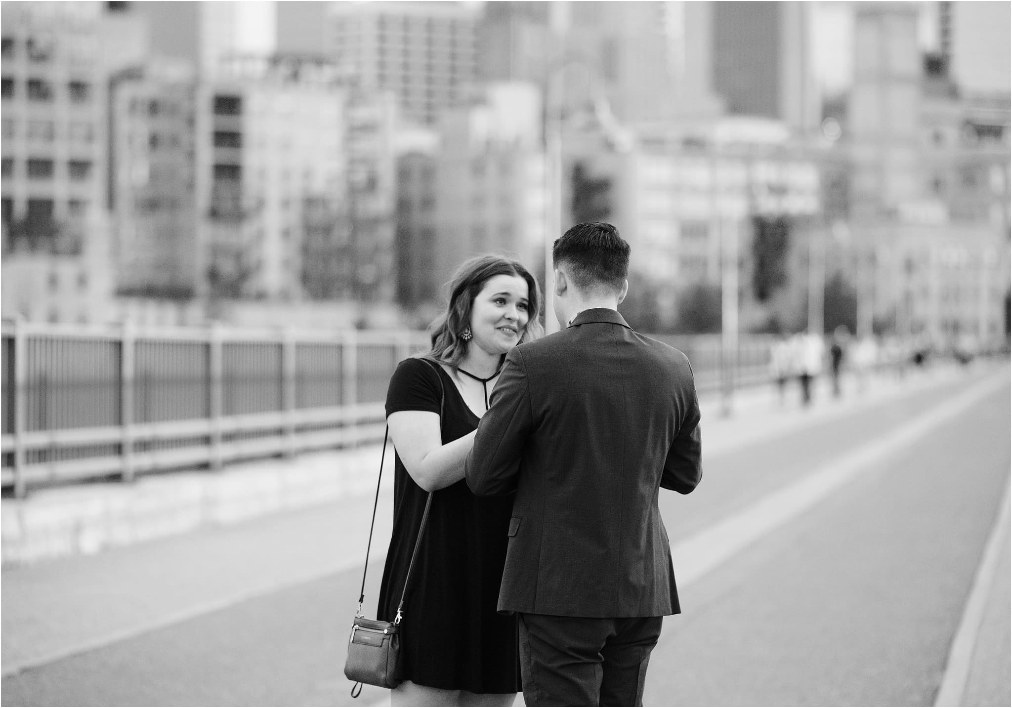 surprise proposal reaction on stone arch bridge