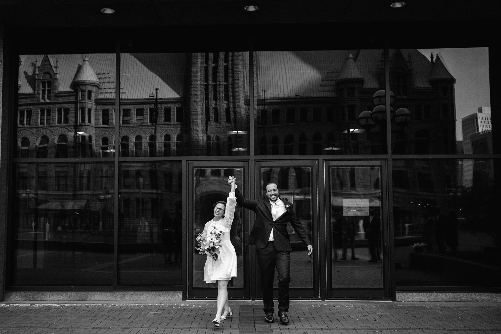 bride and groom celebrate exit at their minnesota courthouse wedding