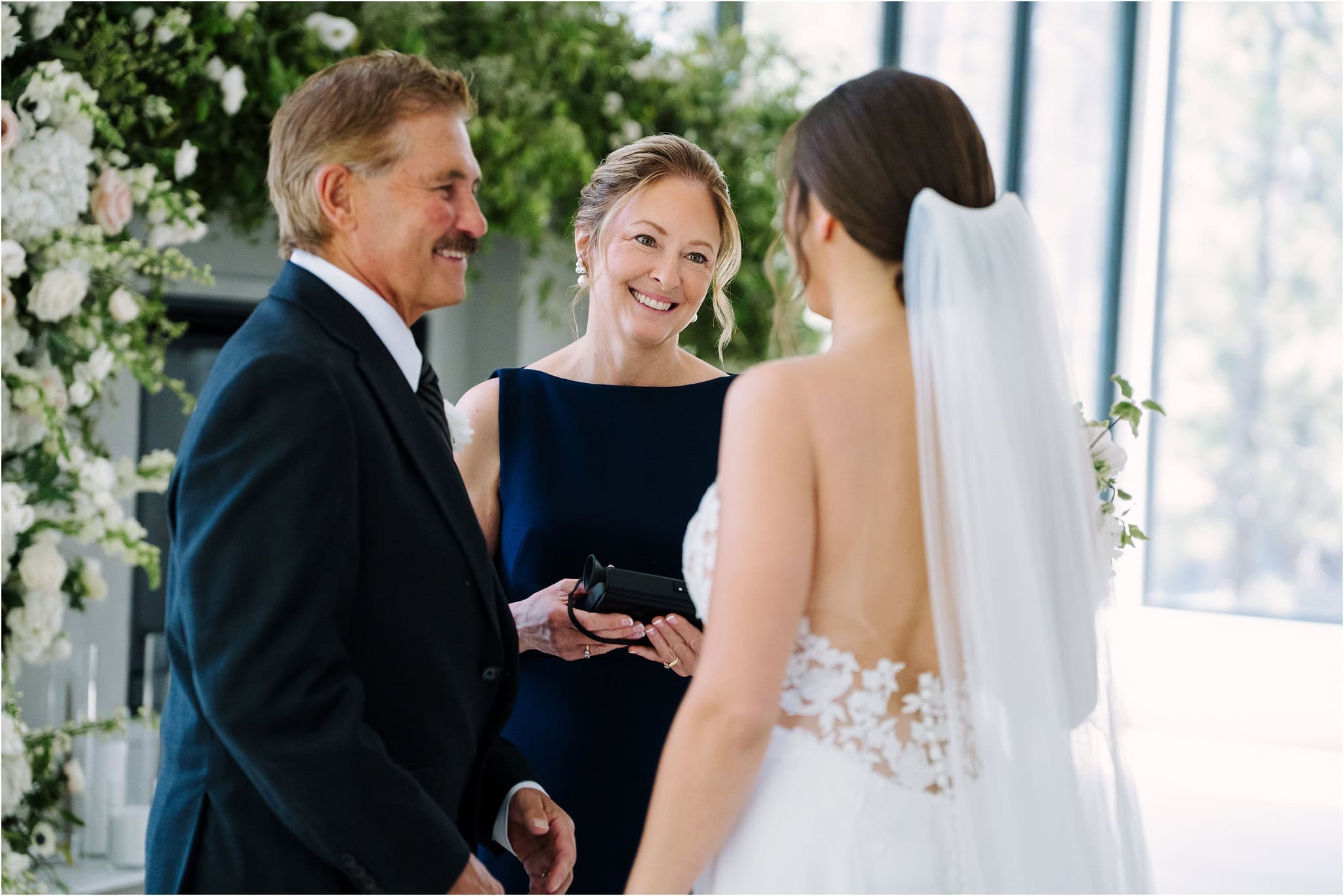 bride has first look with parents during minnesota wedding day